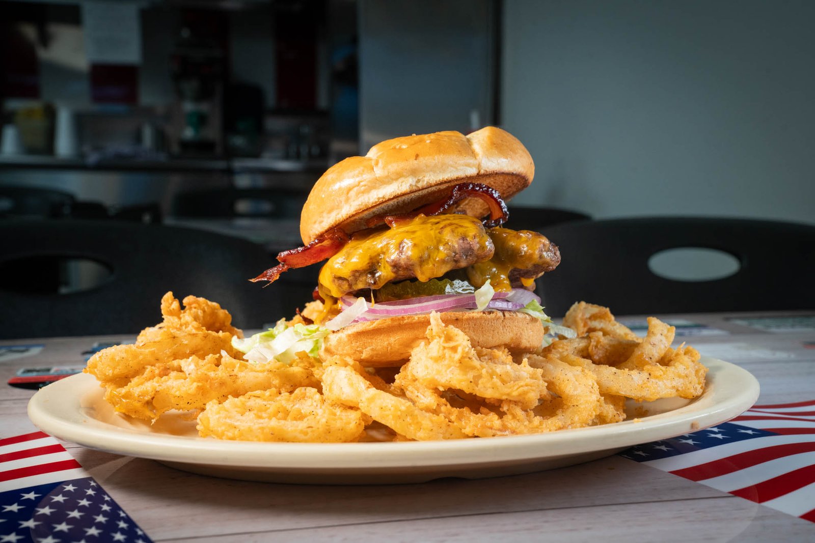 Bacon cheeseburger served with hand breaded onion rings